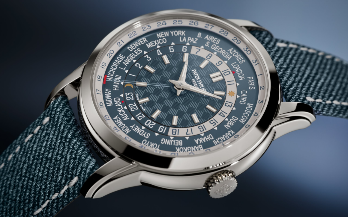 Patek Philippe launches its new 5330G-001, distinguished by a patented world first: a self-winding 240 HU C caliber with an innovative differential system to manage local-time date. This entire mechanism comprises 70 components. The opaline blue-gray dial features a carbon-patterned center. A red dot between Auckland and Midway marks the date-change line on the city disk.