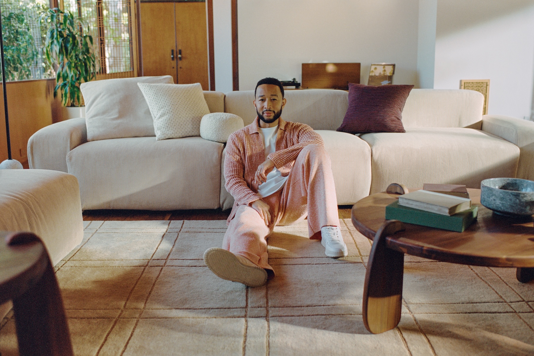 John Legend showcasing The Journeys Collection by Rove Concepts, featuring luxury home furnishings inspired by his personal style and design philosophy