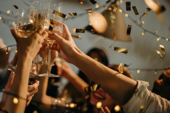 People celebrating and toasting wine glasses at a party