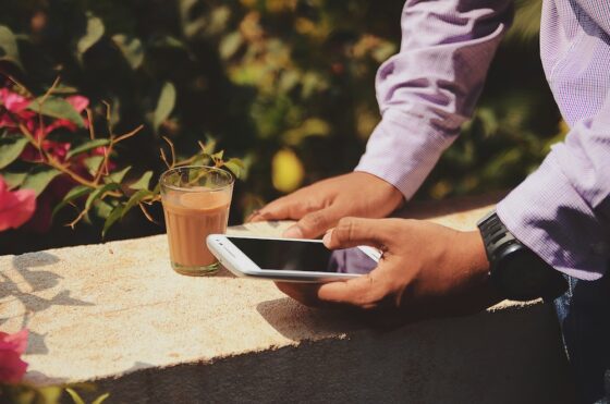 hands of a man in a suit using a mobile phone