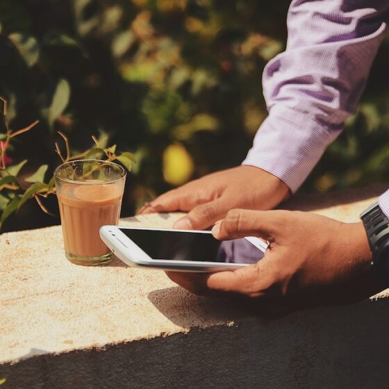 hands of a man in a suit using a mobile phone