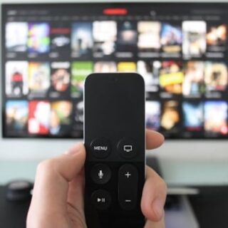 Remote control with TV in the background