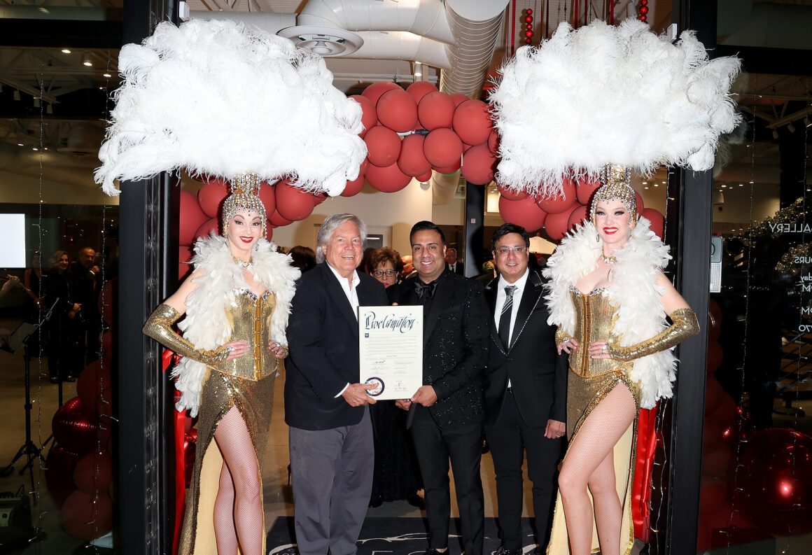 LAS VEGAS, NEVADA - DECEMBER 07: (L-R) Clark County Commissioner Tick Segerblom, Vegas Auto Gallery owner Nick Dossa and Reese Dossa pose with models dressed as Las Vegas showgirls during the grand opening of Vegas Auto Gallery on December 07, 2024 in Las Vegas, Nevada. (Photo by Gabe Ginsberg/Getty Images for Vegas Auto Gallery)