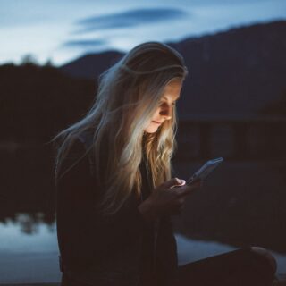 Woman using a cellphone at night