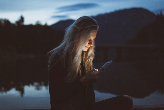 Woman using a cellphone at night