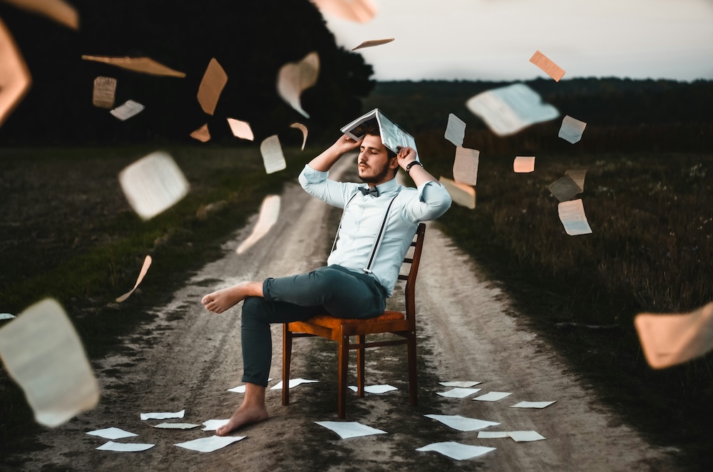 IQ Test guy with books raining down on him.