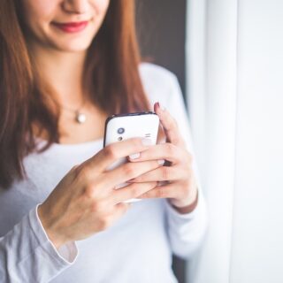 Woman using a cell phone for online gambling