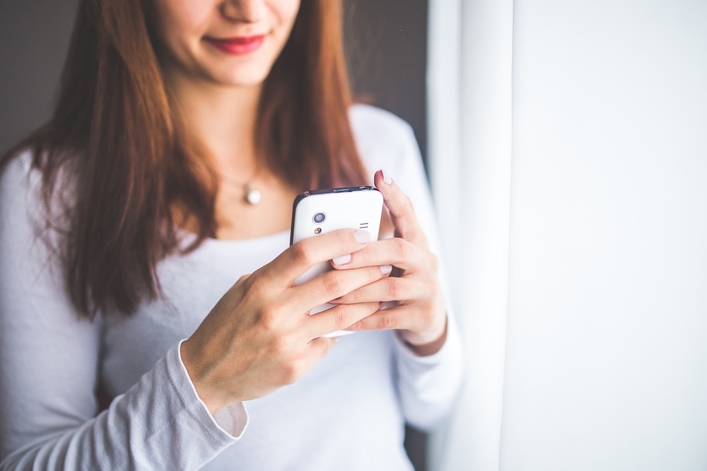 Woman using a cell phone for online gambling