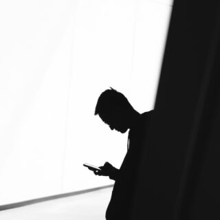 Silhouette of a man on his cell phone.