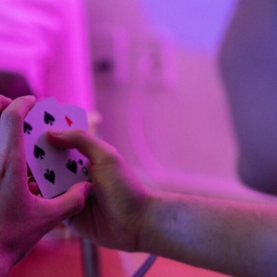 Poker player with purple background and lighting.