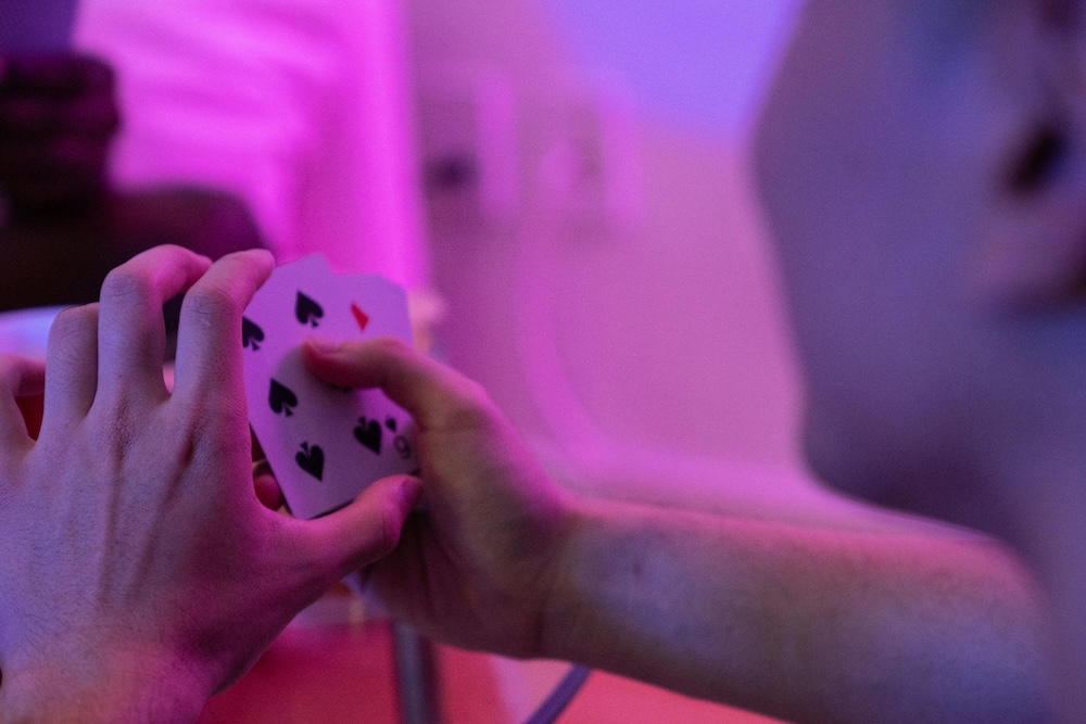 Poker player with purple background and lighting.