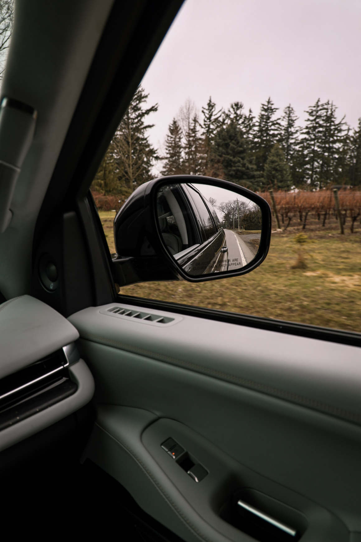 Lincoln black label rear view mirror in the countryside Niagara Ontario road trip