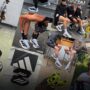White adidas Adizero EVO SL running shoes worn on a city street, highlighting the sleek performance trainer that became one of Summer 2026’s biggest sneaker trends.
