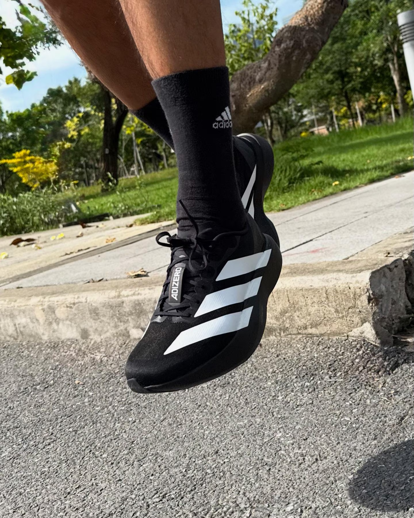 Adidas Adizero EVO SL black with white stripes colourway trending on social